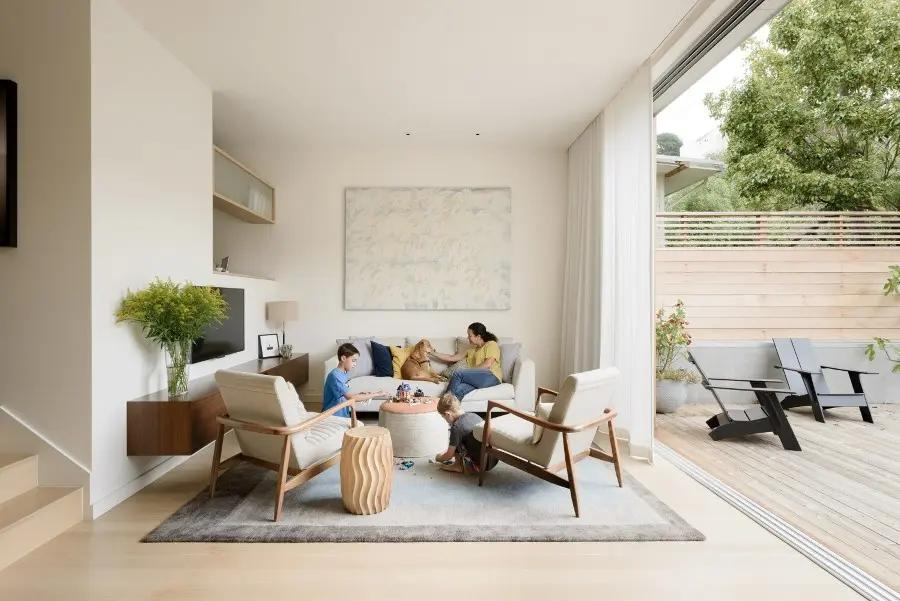 Bright modern living room with family and outdoor deck.